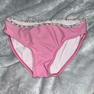 pink swimsuit bottoms with grey cheetah print waistband.